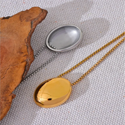 A flat lay of the necklace on a neutral-toned background, highlighting its minimalist design.