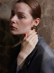 Gold flower earrings styled with casual outfit 