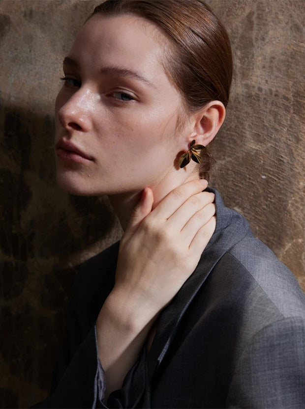 Gold flower earrings styled with casual outfit 