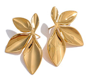Elegant gold flower earrings on clean background 