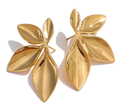 Elegant gold flower earrings on clean background 