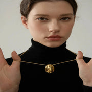  Minimalist necklace styled with formal attire, illustrating its adaptability for various looks.