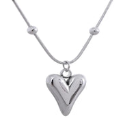 A silver heart pendant necklace displayed flat on a white background