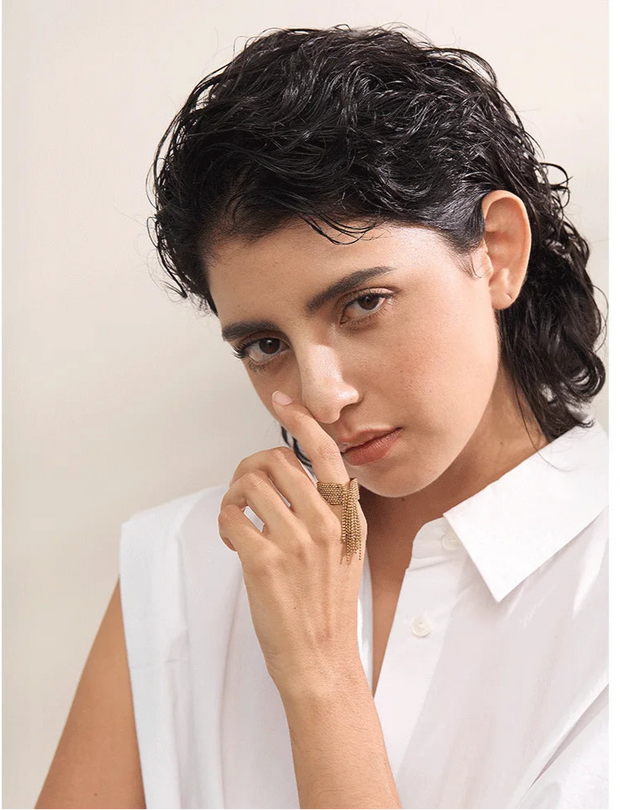 Tassel ring worn by model with trendy outfit