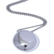 Top view of a sleek silver necklace with a polished finish, laid on a neutral-toned background.